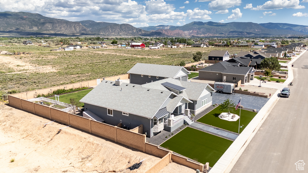 Aerial view of property and surrounding area with a mountain backdrop