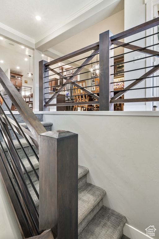Stairway featuring ornamental molding and recessed lighting
