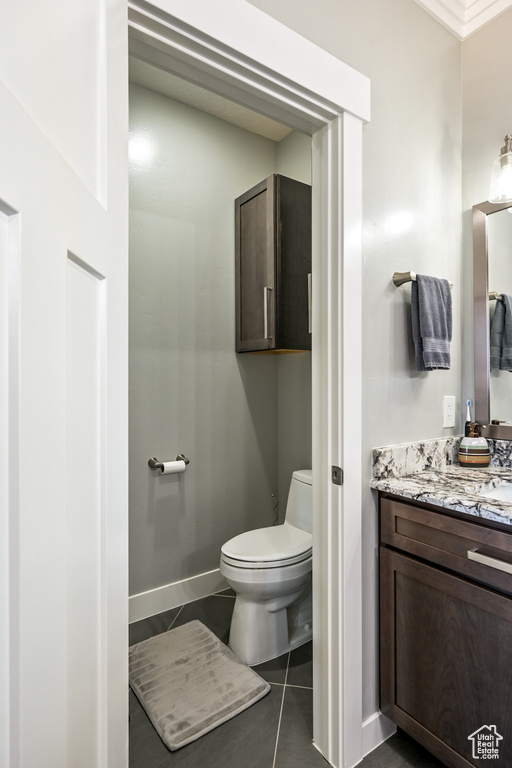 Half bathroom featuring vanity and tile patterned floors