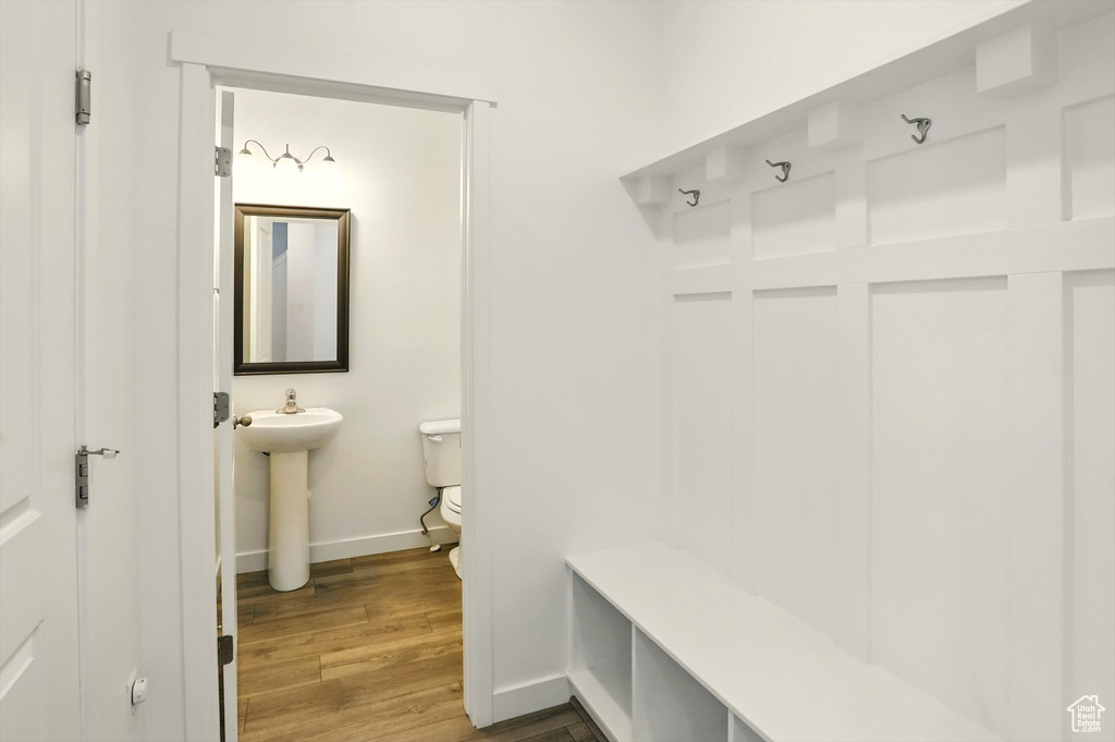 Mudroom with baseboards and wood finished floors