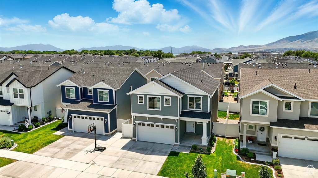 Traditional-style home featuring a residential view, an attached garage, and a mountain view