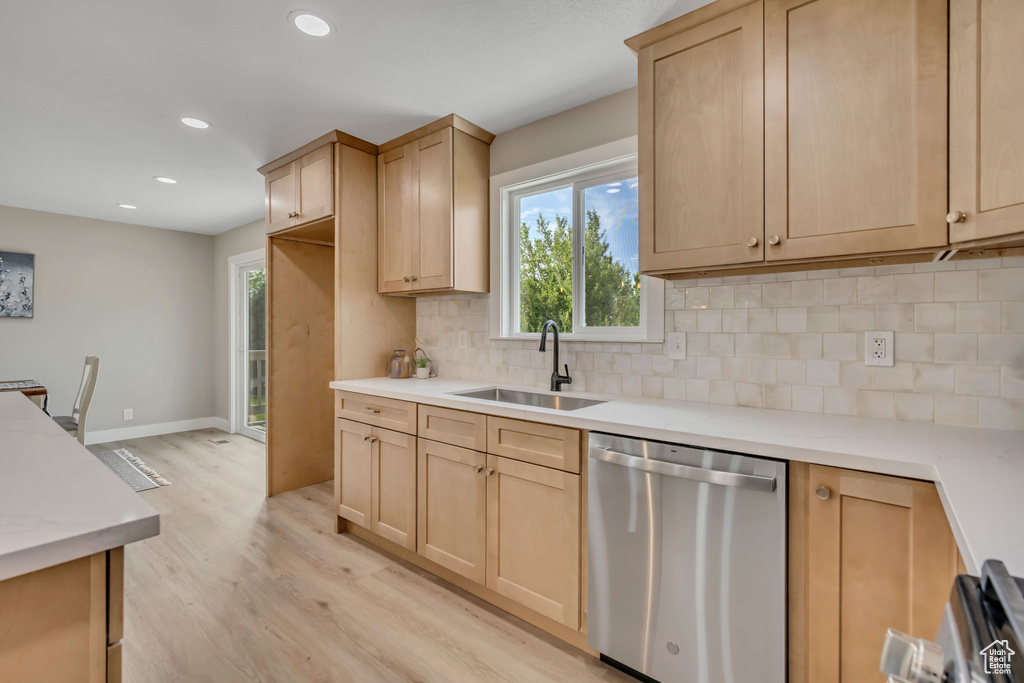 Kitchen featuring dishwasher, light brown cabinets, light wood-style floors, decorative backsplash, and recessed lighting