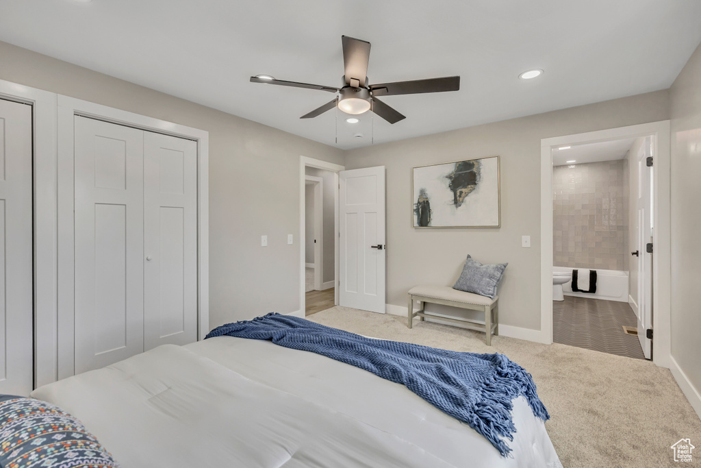 Carpeted bedroom featuring recessed lighting, ensuite bath, and ceiling fan