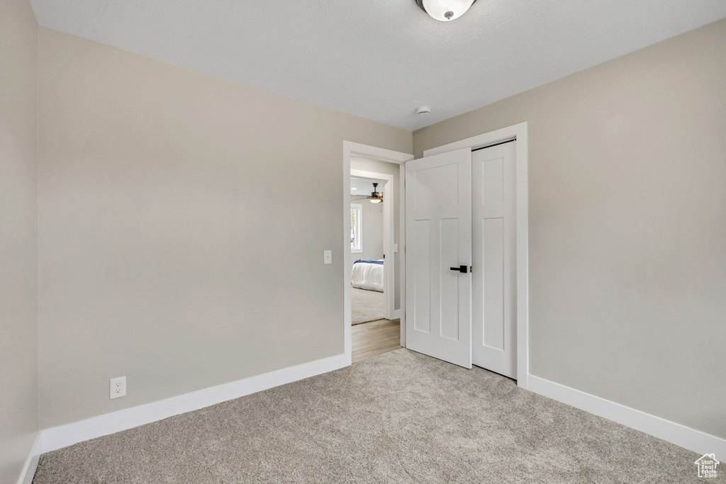 Unfurnished bedroom with carpet flooring and a closet