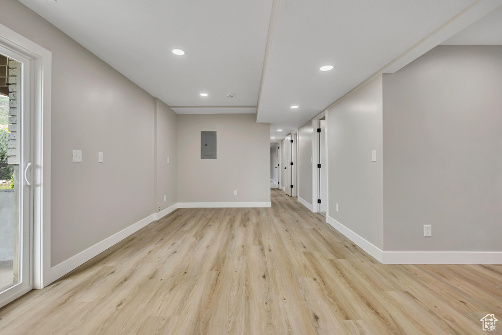 Unfurnished room featuring recessed lighting, electric panel, and light wood-style flooring