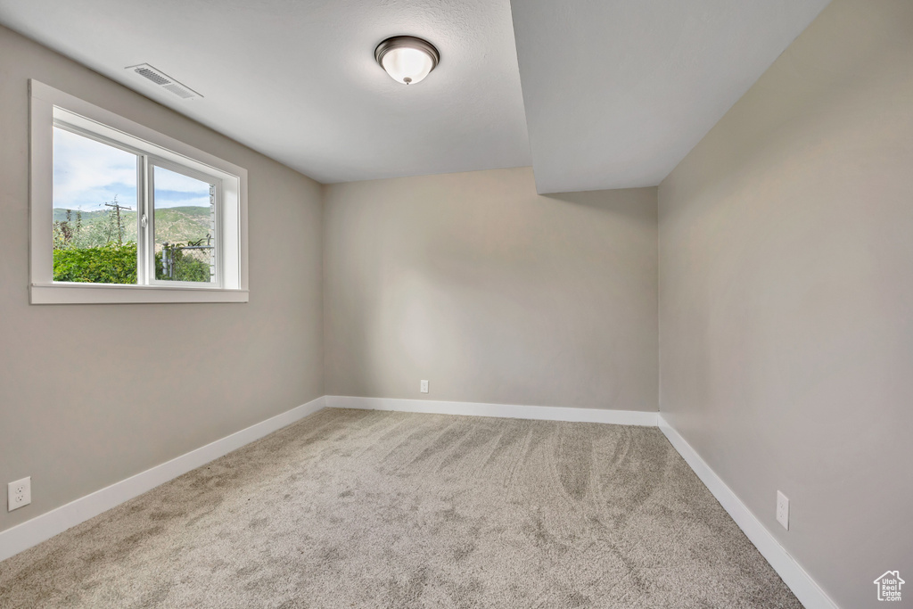 Carpeted empty room with baseboards