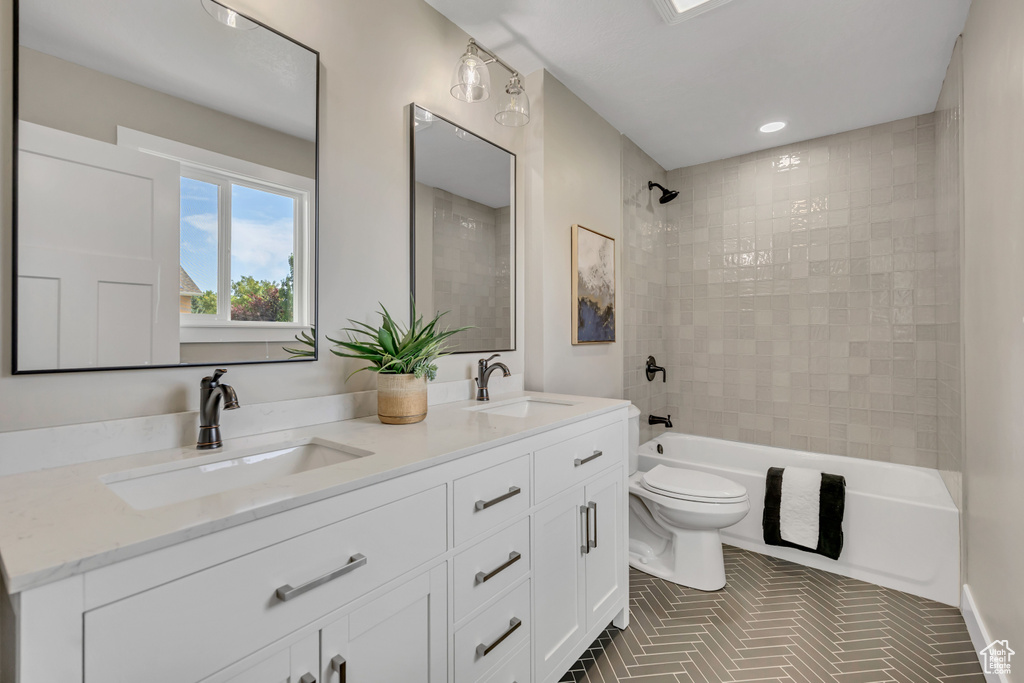 Full bathroom with double vanity,  shower combination, and recessed lighting