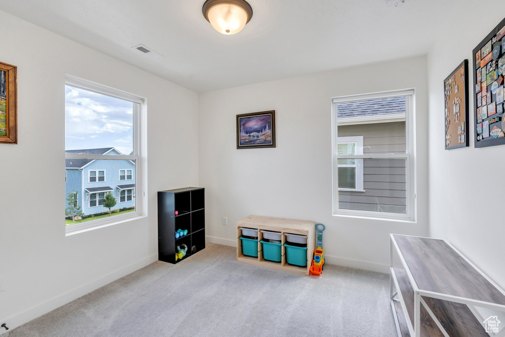 Rec room with baseboards and carpet floors