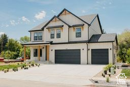 View of front of house with concrete driveway and a garage