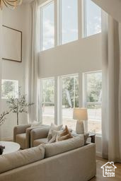 Living room with plenty of natural light and a high ceiling