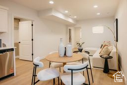 Dining area featuring light wood finished floors and recessed lighting