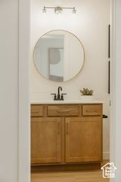 Bathroom featuring vanity and wood finished floors