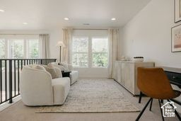 Sitting room with healthy amount of natural light, recessed lighting, and carpet