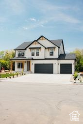 Modern farmhouse style home featuring driveway and a garage