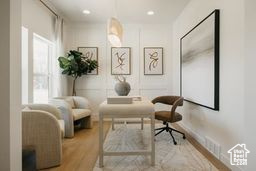 Living area featuring healthy amount of natural light, wood finished floors, and recessed lighting