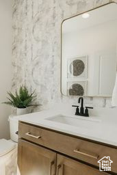 Bathroom featuring vanity and toilet