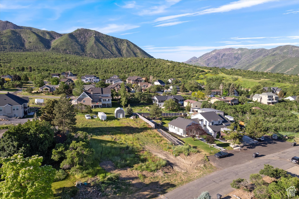 Aerial overview of property's location with nearby suburban area and a mountain backdrop