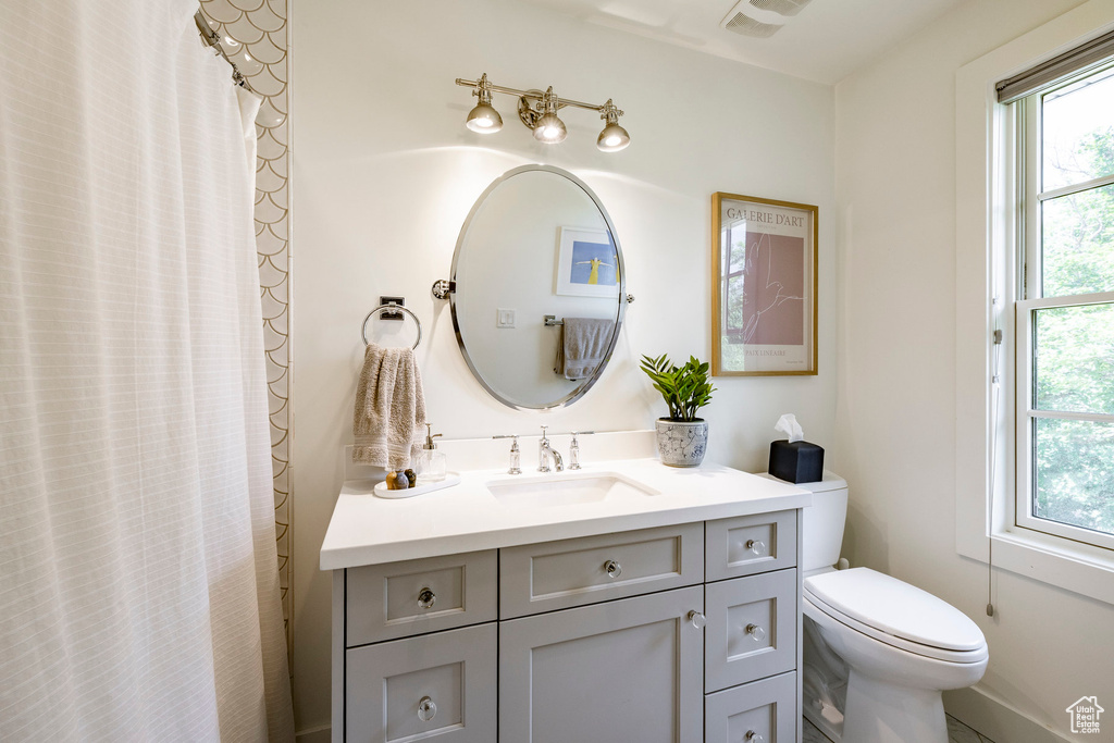 Full bathroom featuring vanity and curtained shower