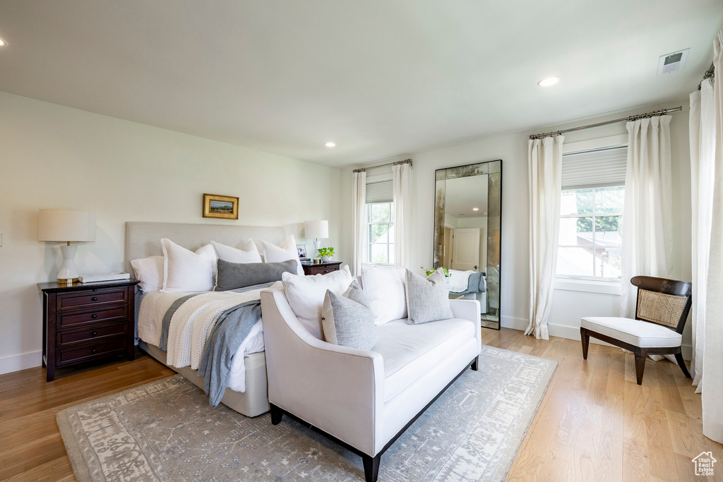 Bedroom featuring light wood-style floors, multiple windows, and recessed lighting