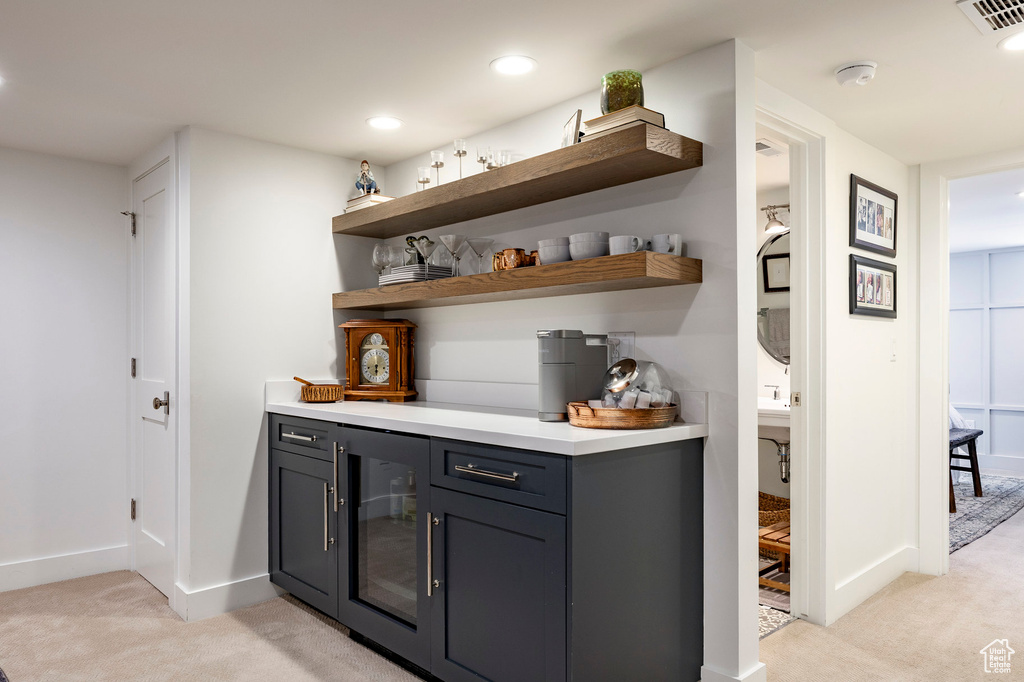Indoor dry bar featuring light colored carpet and recessed lighting