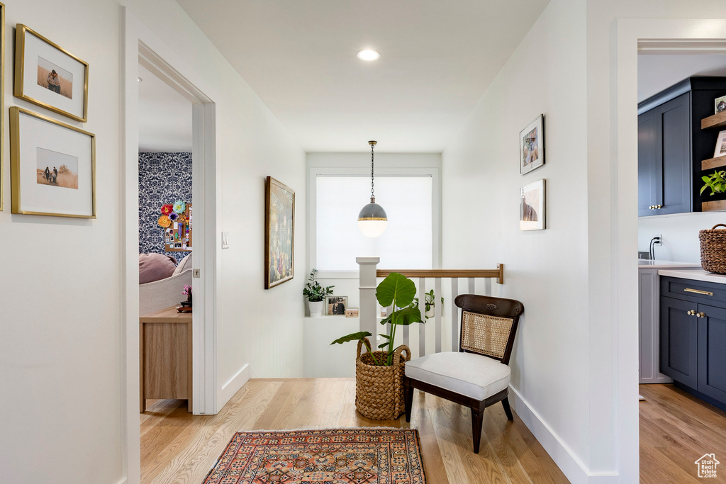 Hall featuring light wood-style flooring and recessed lighting
