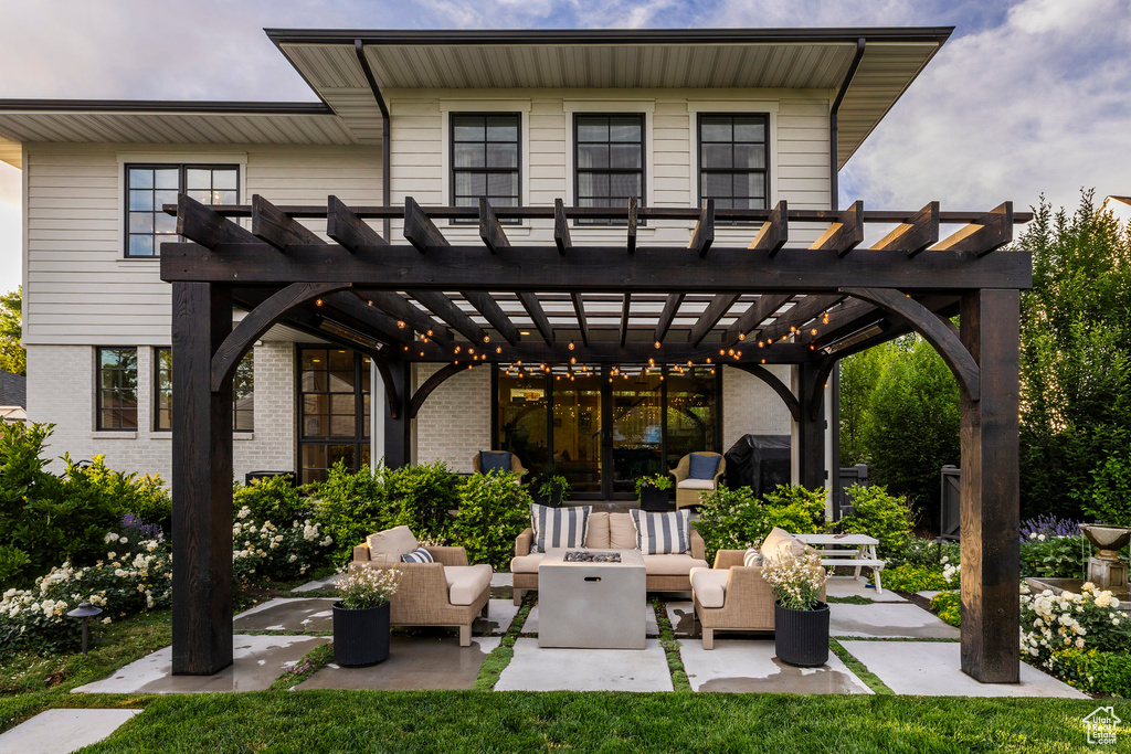 View of patio with an outdoor living space with a fire pit and a pergola