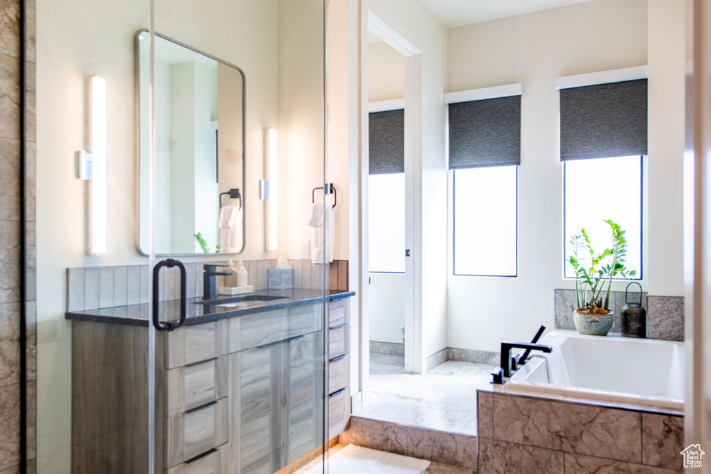 Bathroom featuring a garden tub and a stall shower