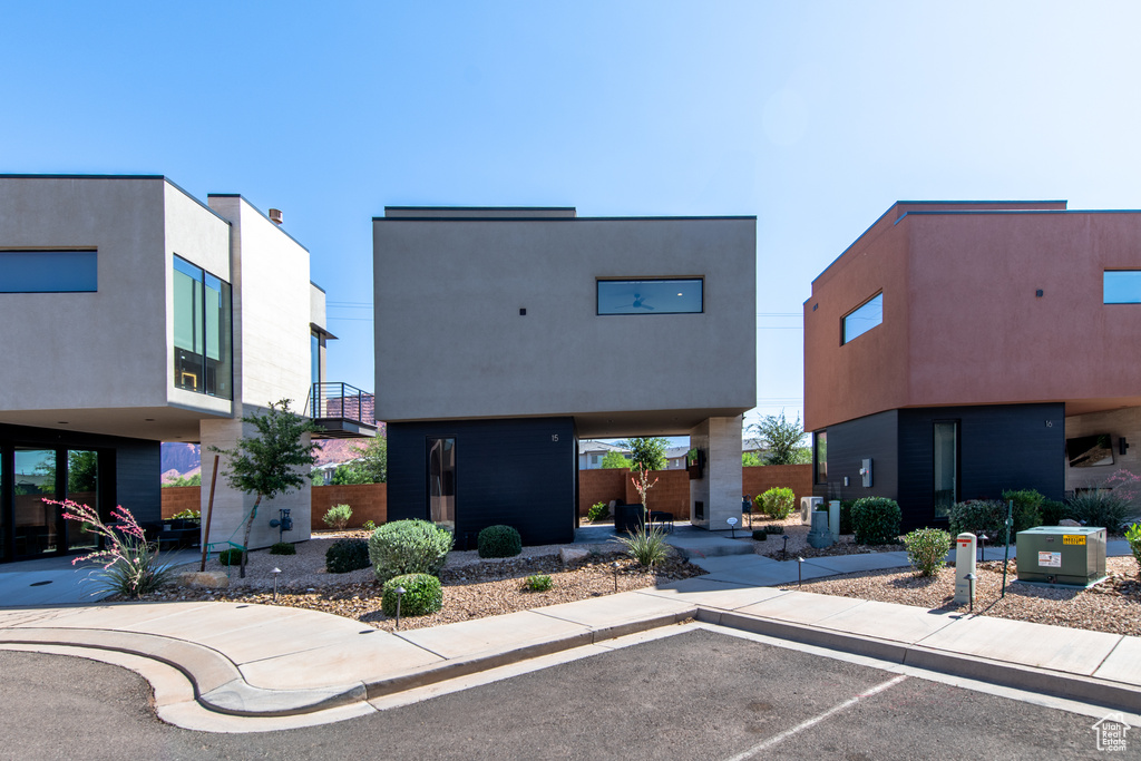 View of building exterior featuring uncovered parking
