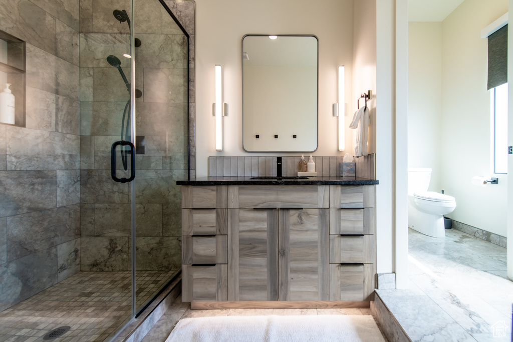 Full bath with a stall shower and vanity
