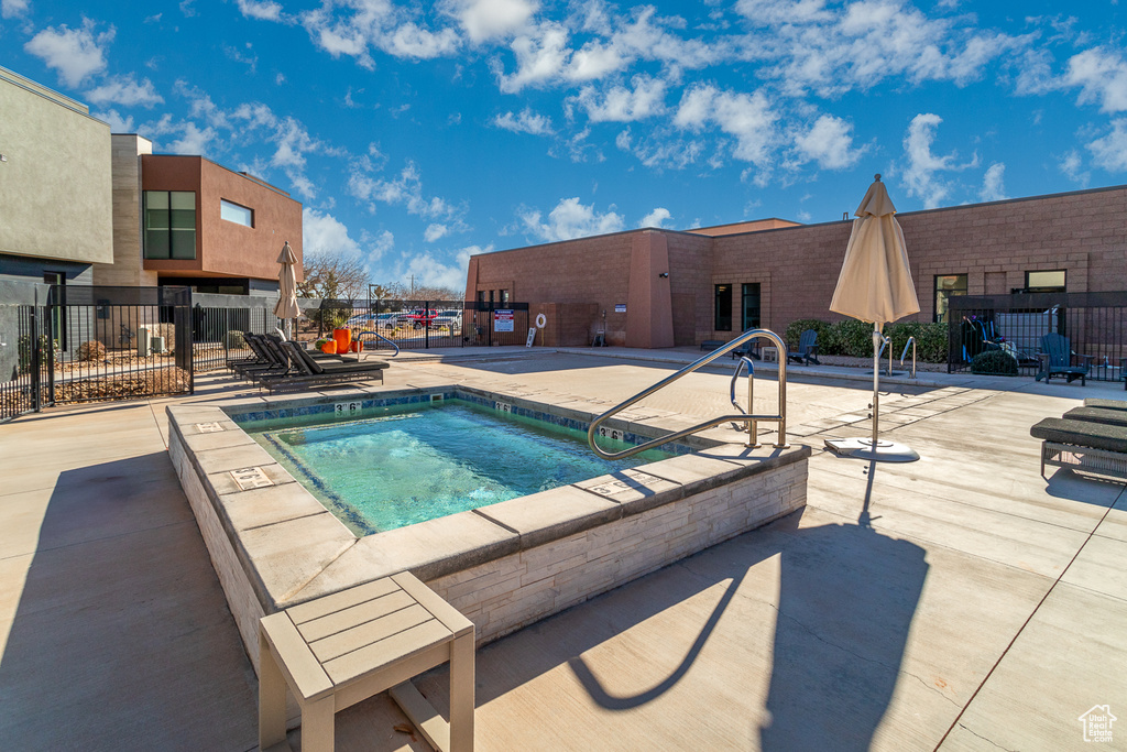 View of swimming pool with a community hot tub, a patio area, and a pool