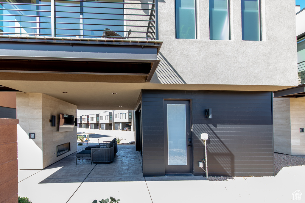 View of patio with an outdoor living space with a fireplace