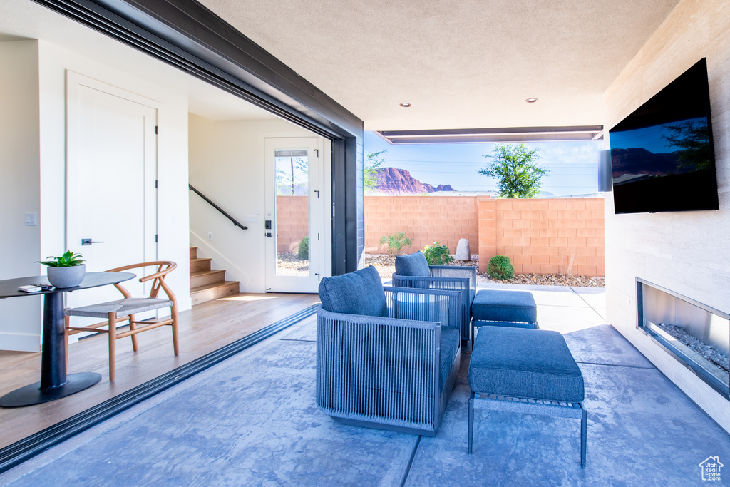 View of patio with an outdoor living space with a fireplace