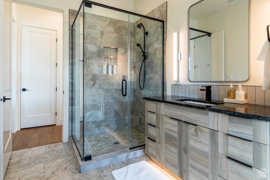 Bathroom with vanity and a stall shower