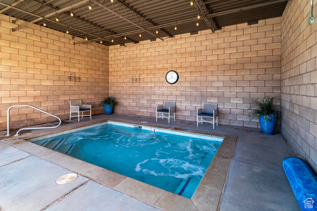 Indoor pool featuring a patio area