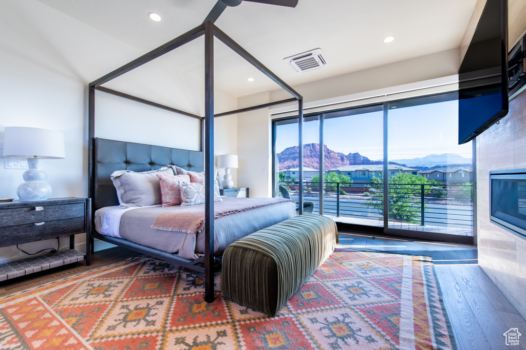 Bedroom featuring wood finished floors, access to outside, and recessed lighting