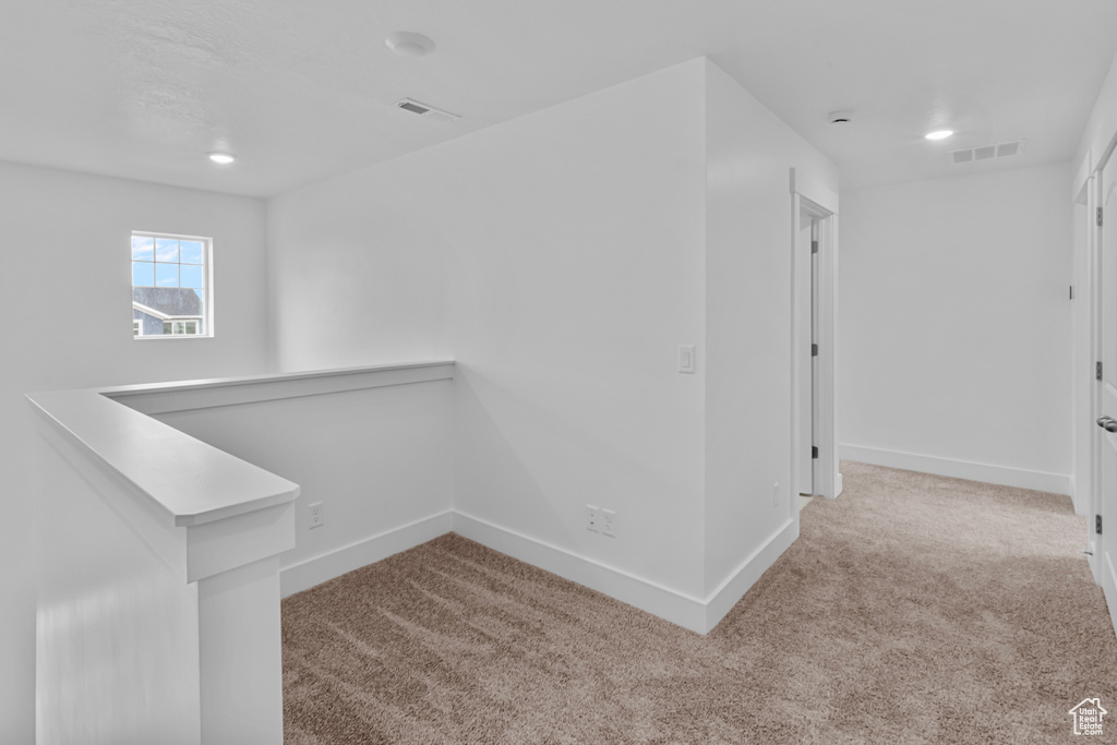 Hall featuring carpet floors, an upstairs landing, and recessed lighting