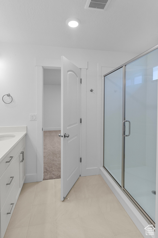 Full bathroom featuring a stall shower and vanity