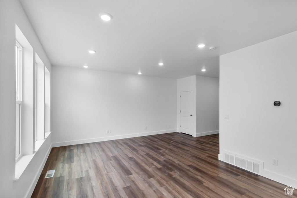 Unfurnished room with recessed lighting, dark wood finished floors, and a smoke detector