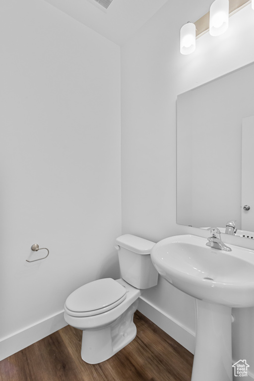 Bathroom featuring baseboards and wood finished floors