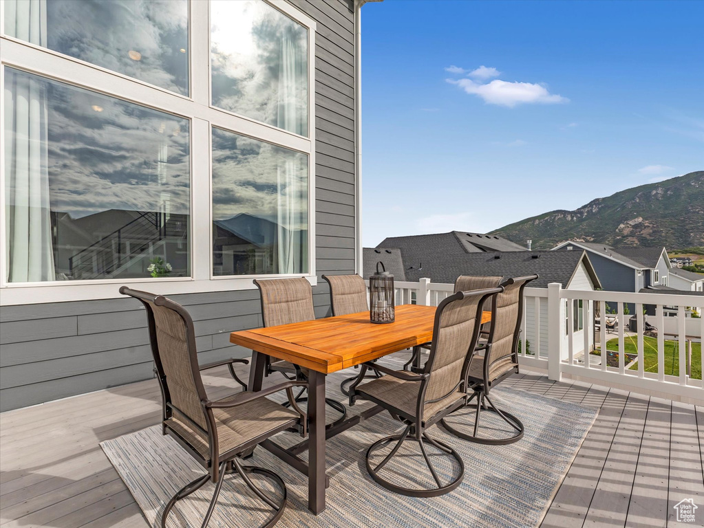 Deck featuring a mountain view and outdoor dining area