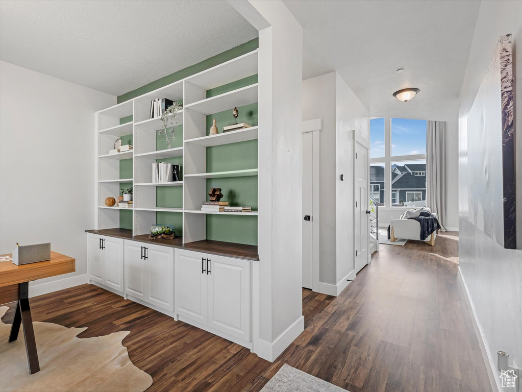 Unfurnished office with dark wood-style flooring