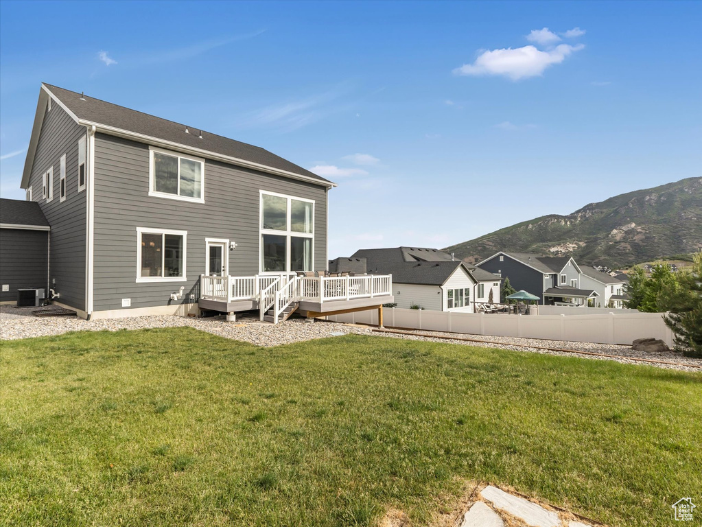 Back of property featuring a deck with mountain view
