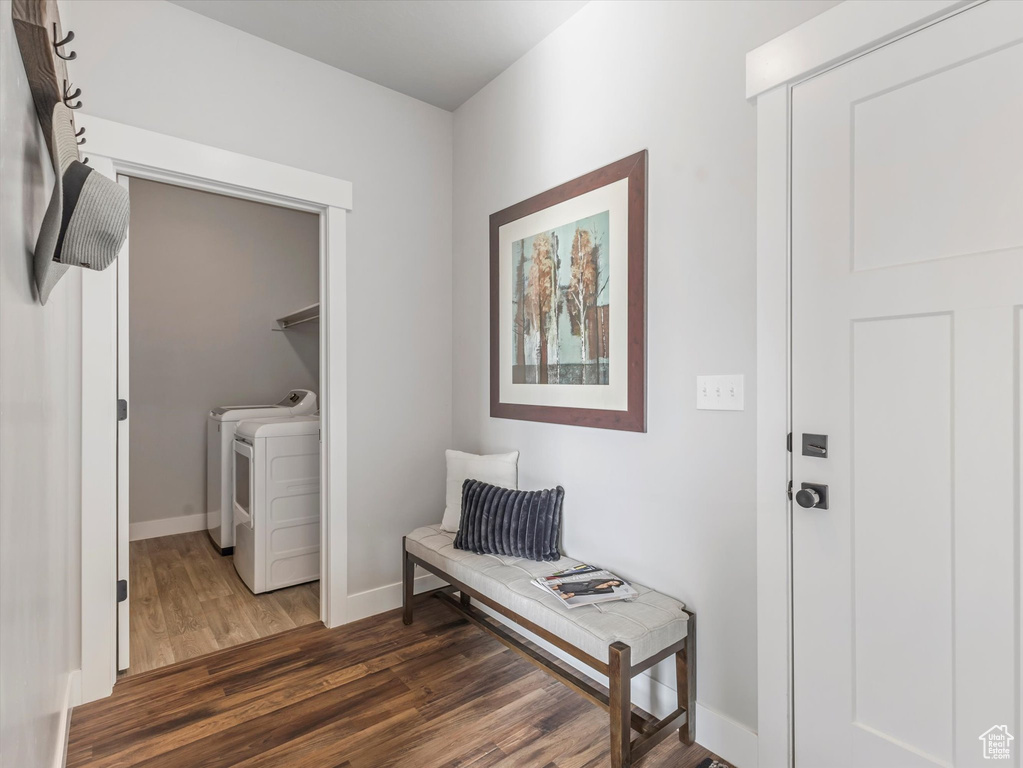 Foyer with washing machine and dryer and wood finished floors