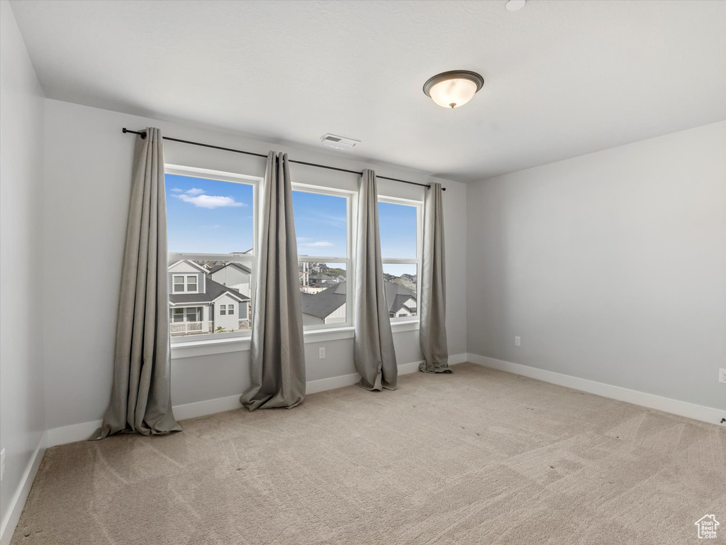 Unfurnished room with carpet floors and baseboards