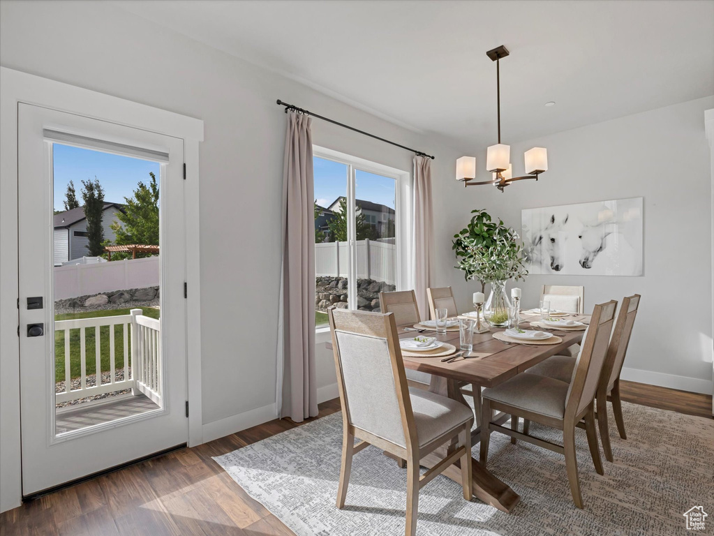 Dining space featuring a chandelier and wood finished floors
