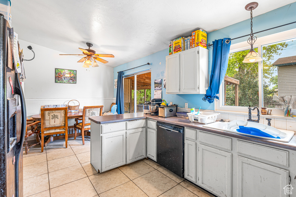 Kitchen with dishwasher, a peninsula, a ceiling fan, and white cabinets