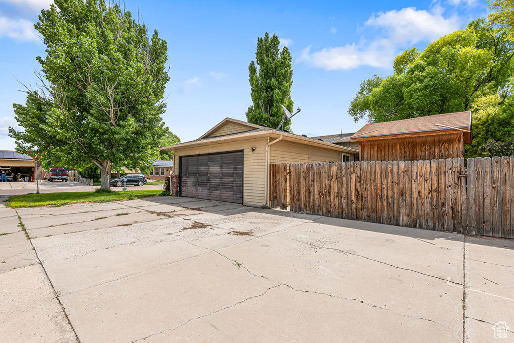 Garage featuring concrete driveway