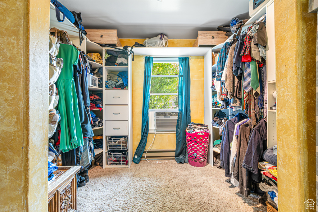 Walk in closet featuring carpet, cooling unit, and baseboard heating