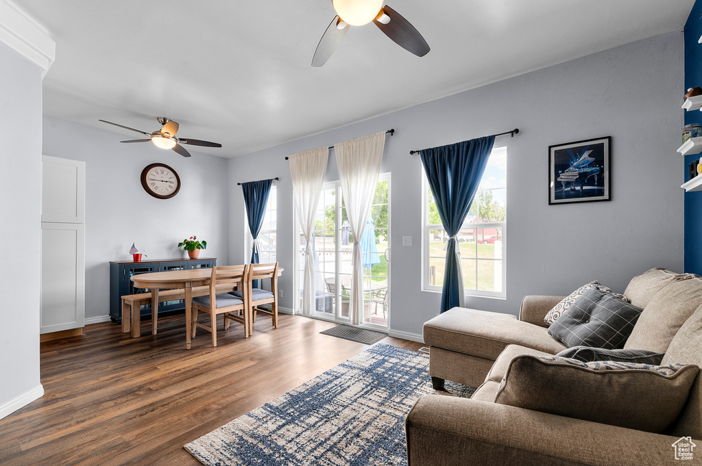 Living area with ceiling fan and wood finished floors