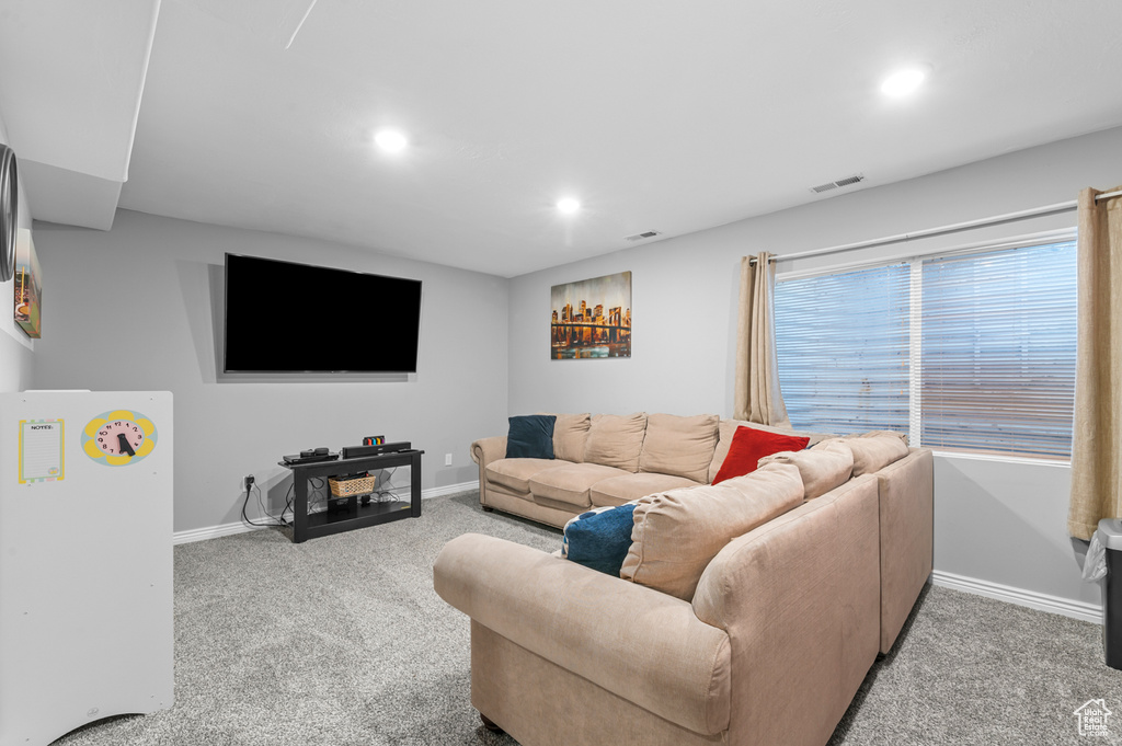 Living area with recessed lighting and carpet flooring